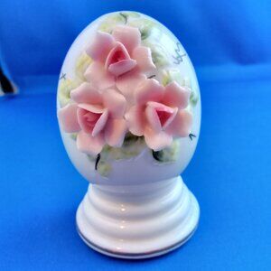Vintage porcelain egg figurine with pink flowers